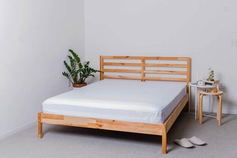 wooden bed with white mattress