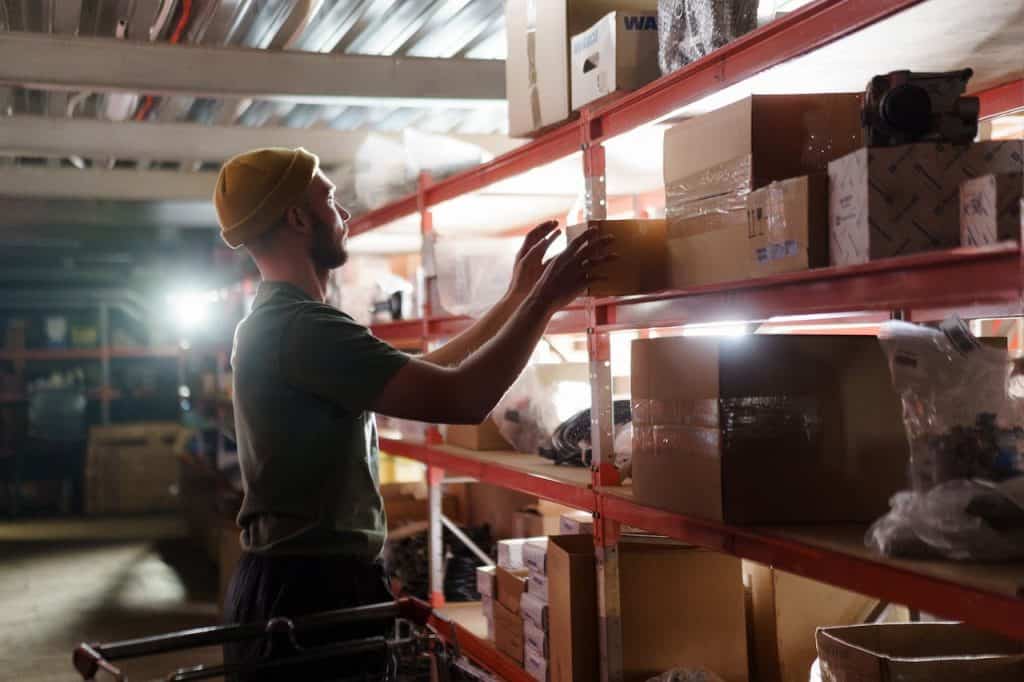A man looking for items in a storage facility