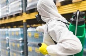 man killing pests in a factory