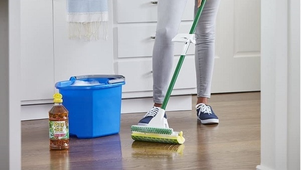 woman cleaning floor with pine sol