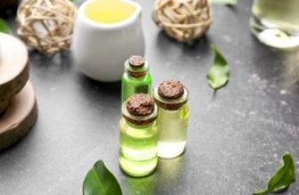 tea tree oil flasks on grey background