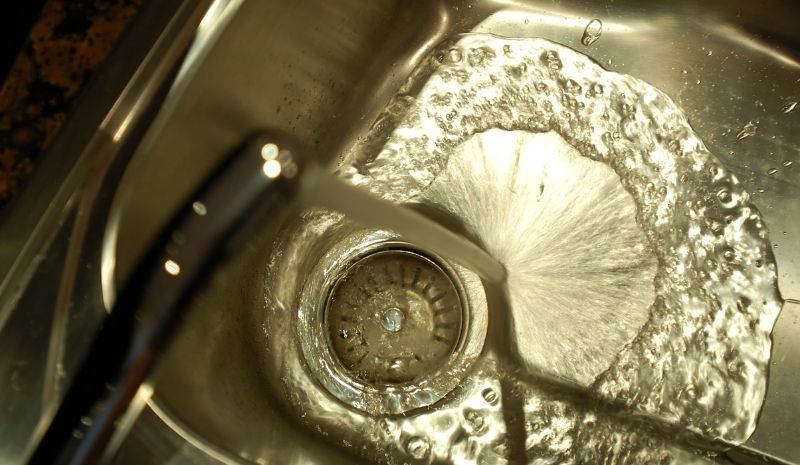 water from the tap into the sink