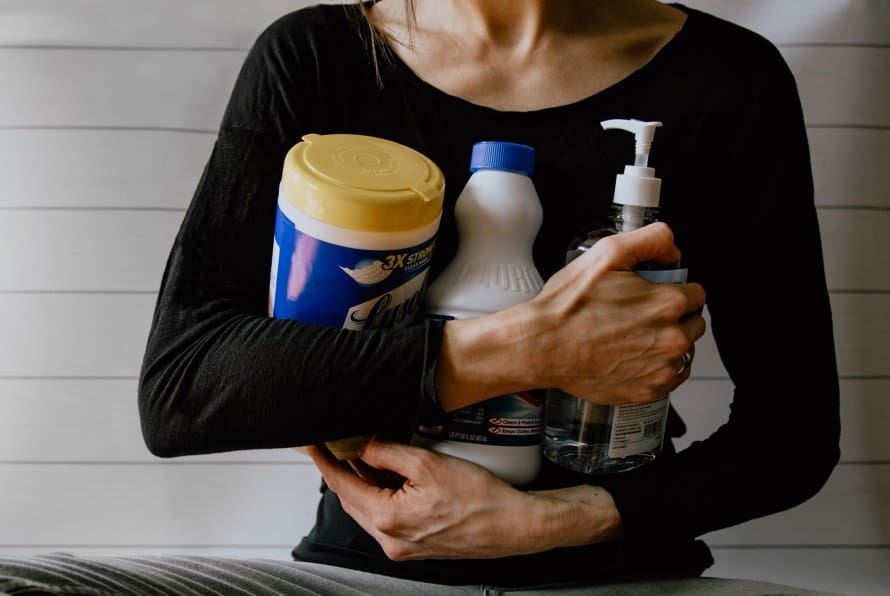 woman holds cleaning tools