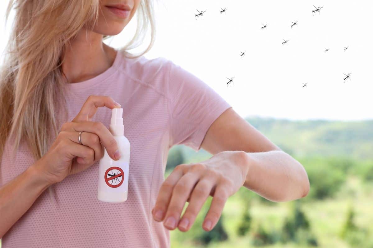 woman using mosquito repellent